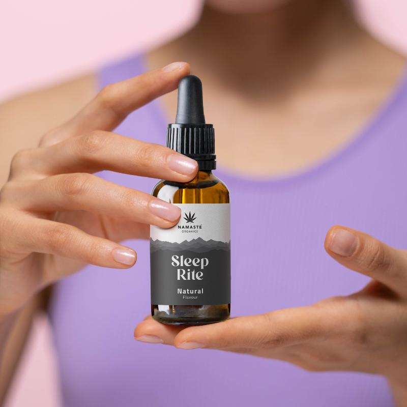 Bottle labeled 'Sleep Rite' held by a person with a blurred background