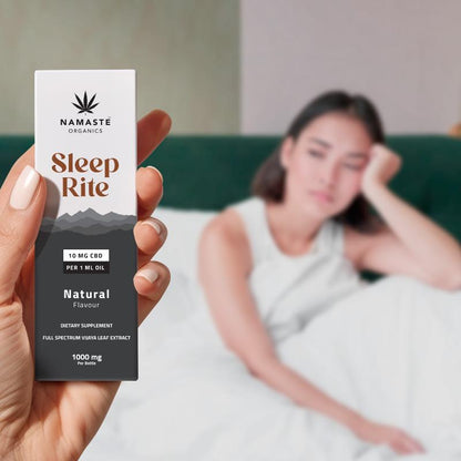 Hand holding a 'Sleep Rite' CBD Oil supplement package with a blurred background of a person on a couch.