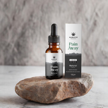 Namaste Naturals Full spectrum CBD Oil product on a stone surface with a neutral background