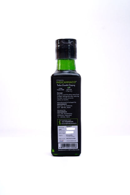 Black bottle with green label on a white background