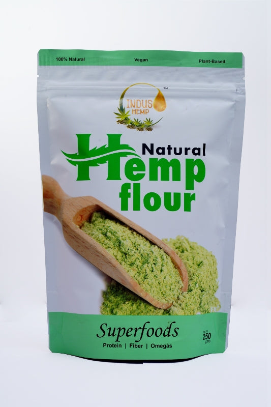 Bag of natural hemp flour with a wooden scoop on a white background