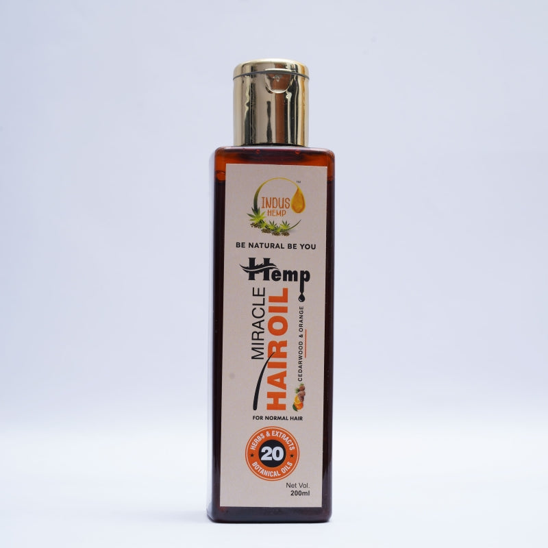 Bottle of Miracle Hemp Hair Oil on a light gray background