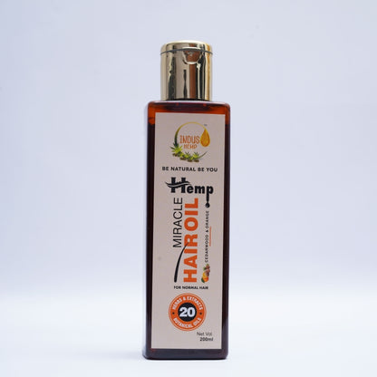 Bottle of Miracle Hemp Hair Oil on a light gray background