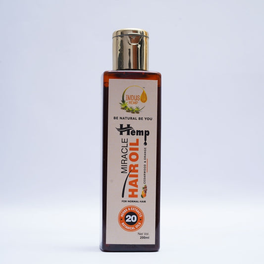 Bottle of Miracle Hemp Hair Oil on a light gray background