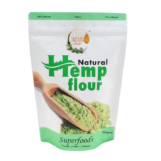 Bag of natural hemp flour with a wooden scoop on a white background