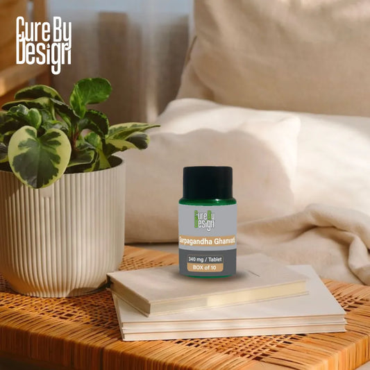 Cure By Design supplement bottle on a table with a plant and notebook in a home setting