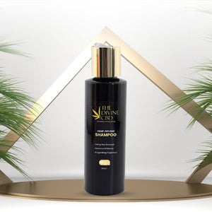 Black shampoo bottle with a gold cap, labeled 