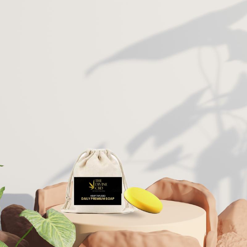 Drawstring pouch with yellow soap on a round platform against a neutral background with plant shadows.


