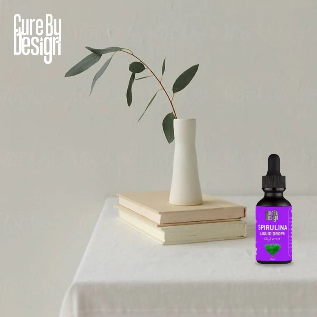 Spirulina liquid drop bottle on a table with a vase and books in the background