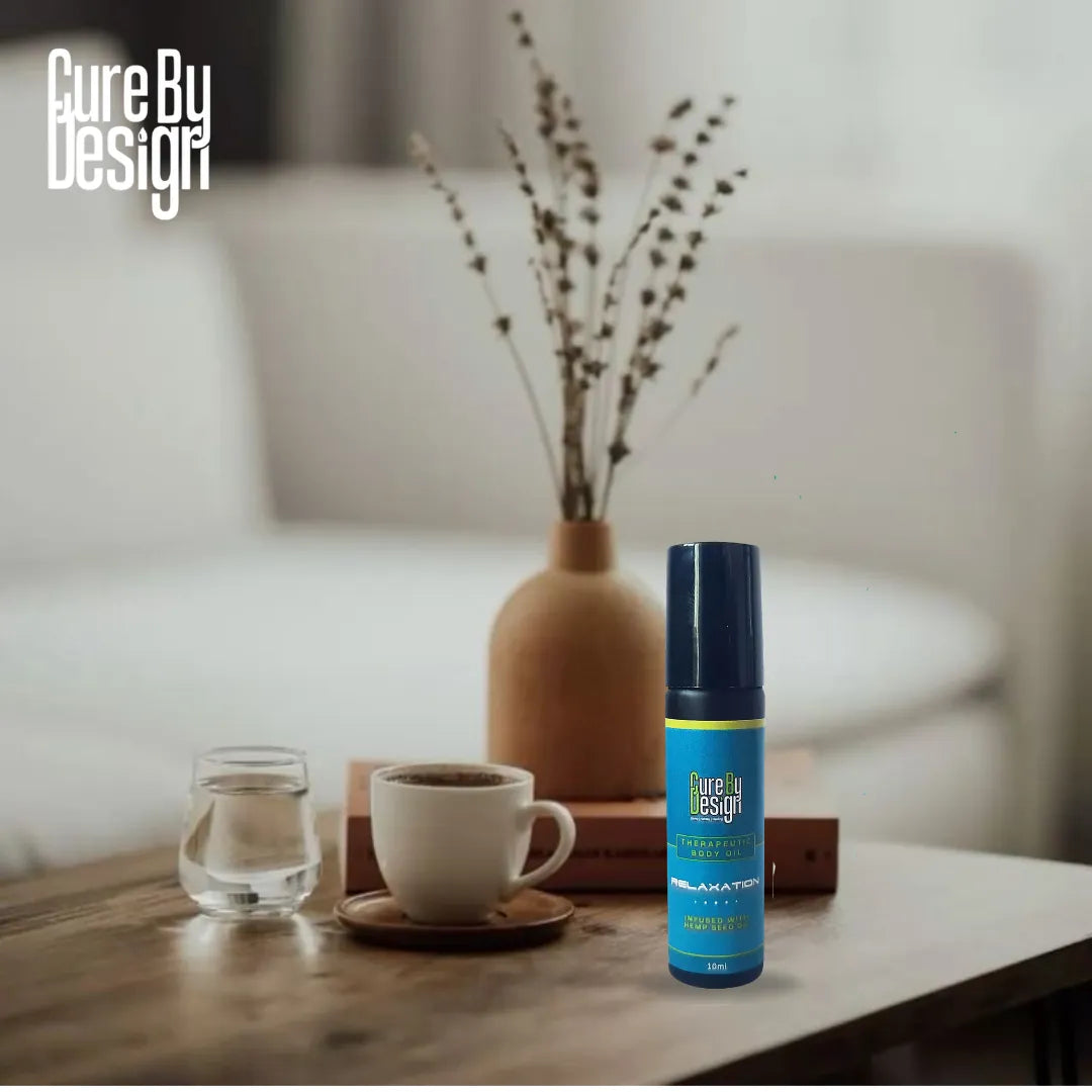 Blue spray bottle labeled 'Therapeutic Healing Blend Roll-on - Relaxation' on a table with a cup and glass in a home setting.