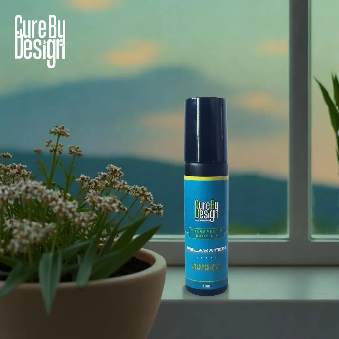 Blue bottle labeled 'Therapeutic Healing Blend Roll-on - Relaxation' on a windowsill with plants and a scenic view.