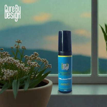 Blue bottle labeled 'Therapeutic Healing Blend Roll-on - Relaxation' on a windowsill with plants and a scenic view.