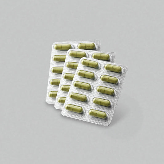 Multiple packs of green vijaya capsules on a gray background