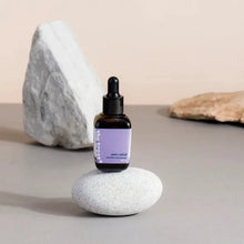 Load image into Gallery viewer, a bottle of cbd oil over the pebble stone.
