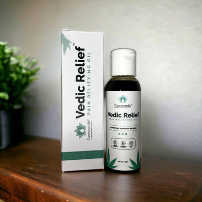  Bottle and box of Cannavedic Vedic Relief Pain Relieving Oil on a wooden surface.

