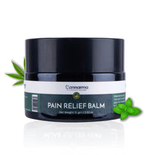 Load image into Gallery viewer, A jar of Cannarma Pain Relief Balm on a lwhite background with cannabis leaves on either side.
