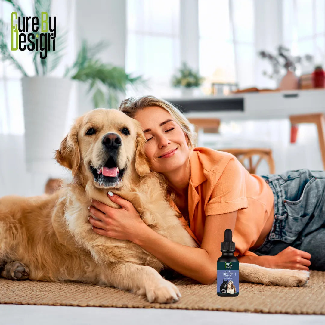 Woman lying on the floor with a golden retriever and a bottle of pet cbd product in the foreground.