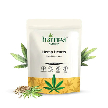 A package of Hampa Nutrition Hempa Hemp Hearts, shelled hemp seeds. The packaging is white with green and yellow accents, and there are hemp seeds visible in front of the package.